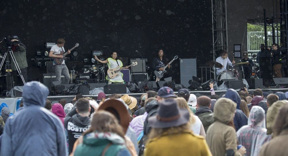 Deerhoof performs to a rain soaked crowd Friday afternoon. (Jesse Costa/WBUR)