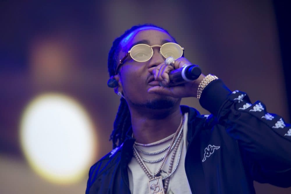 Offset of Migos emerges onto the stage. (Jesse Costa/WBUR)