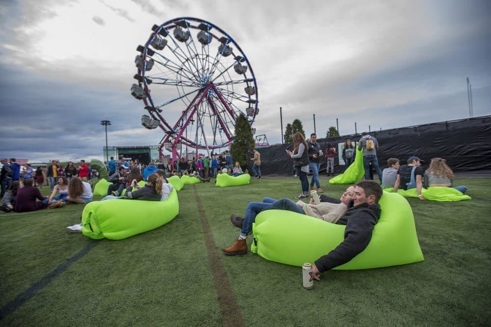 Brendan Legg and Jamie Toner relax in an air hammock at Boston Calling Friday afternoon. (Jesse Costa/WBUR)