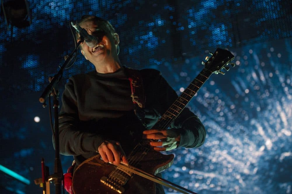 Jónsi, of Icelandic post-punk band Sigur Rós, plays a guitar with a violin bow. (Jesse Costa/WBUR)