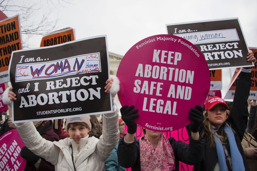 A pro-abortion rights activist (center) demonstrates in the middle of anti-abortion activists as they demonstrate in front of the Supreme Court during the March For Life in Washington, D.C., in January 2017. At least half of all states in the U.S. have imposed restrictions on abortion in the decades following Roe v. Wade, the 1973 Supreme Court decision recognizing a woman's right to abortion, according to the Guttmacher Institute. (Jim Watson/AFP/Getty Images)