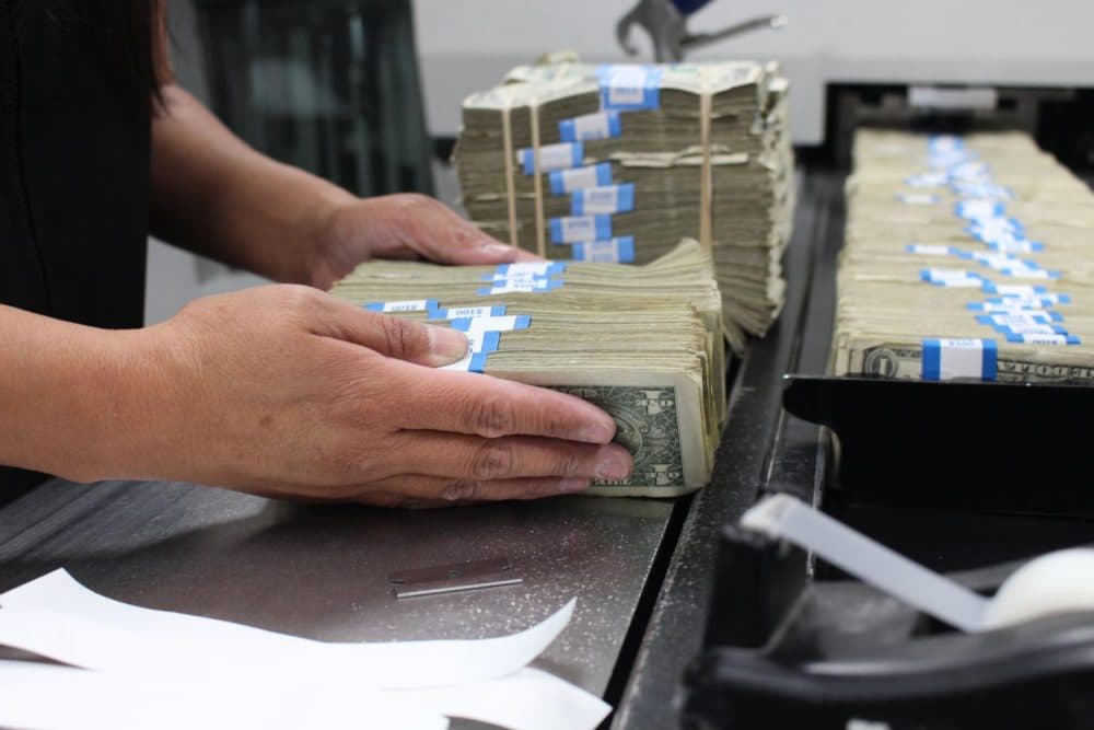 An employee prepares to feed currency into a machine at the Phoenix Processing Center. (Courtesy of the Federal Reserve)