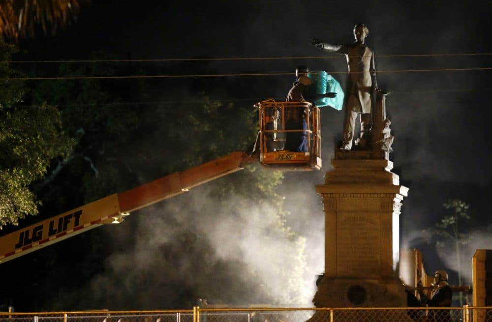 Workers prepare to take down the Jefferson Davis statue in New Orleans, Thursday, May 11, 2017. This was the second of four Confederate monuments slated for removal in a contentious process that has sparked protests on both sides. (Gerald Herbert/AP)