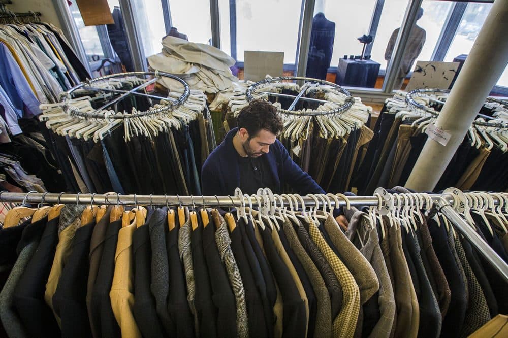 Asa Zabarsky files through a rack of suit jackets at Keezer's. Even though he’s sold the building, owner Len Goldstein has yet to sell the actual business. He's still talking to potential buyers but says many have been discouraged once he describes how much work is involved. (Jesse Costa/WBUR)