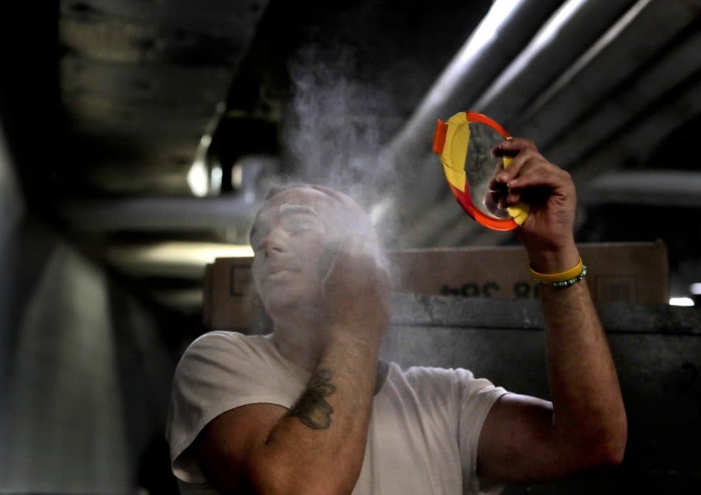 Ringling Bros. boss clown Sandor Eke dusts his face with powder before performing in a show on May 5. (Julie Jacobson/AP)