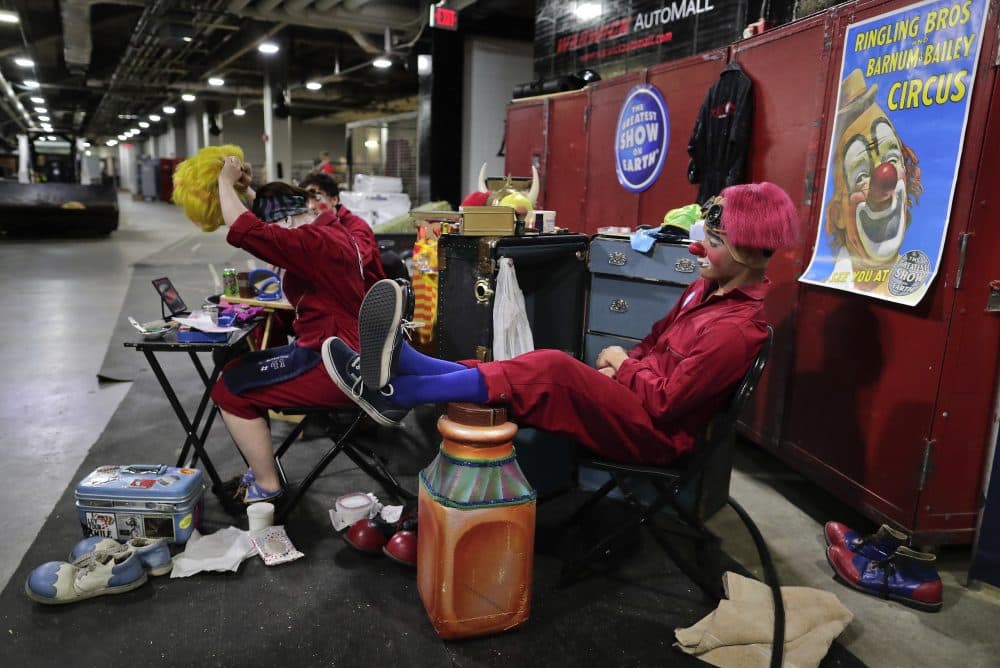 Ringling Bros. clown Brian Wright relaxes before a show as Truett Adams puts on a wig on May 4. (Julie Jacobson/AP)