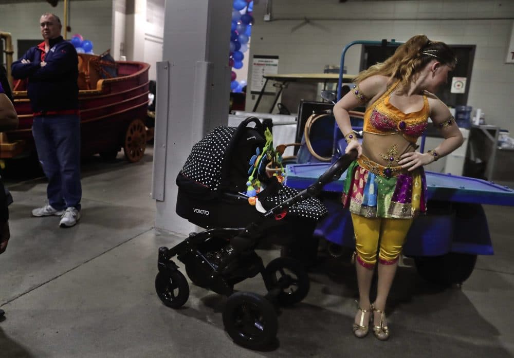 Ringling Bros. high wire performer Anna Lebedeva stands next to her 3-month-old son, Amir, in his stroller while waiting to go on for the show's finale on May 5. (Julie Jacobson/AP)