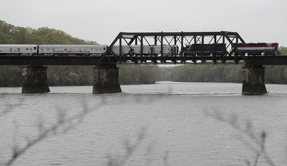 The Ringling Bros. and Barnum &amp; Bailey Circus red unit train passes over a bridge in Enfield, Conn. on its way to Providence, R.I. It is the last circus to travel by train. (Julie Jacobson/AP)