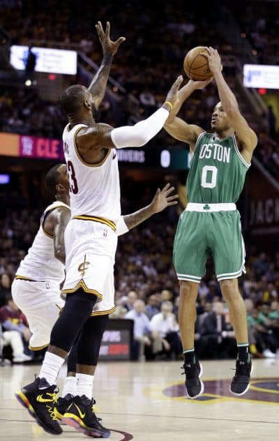 Boston Celtics' Avery Bradley (0) shoots over Cleveland Cavaliers' LeBron James (23) and J.R. Smith (5) during the first half of Game 3. (Tony Dejak/AP)