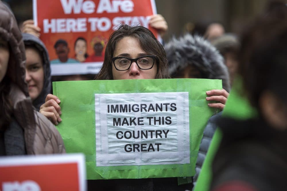 During a SEIU immigrant rally in Boston back in January, a woman holds a sign that reads, &quot;Immigrants Make This Country Great.&quot;. (Jesse Costa/WBUR)