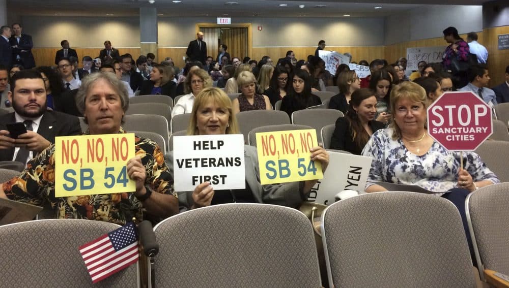 For months, debates over sanctuary cities have been happening across the country. Here, opponents of a California proposal that would create a statewide sanctuary for immigrants in the country illegally prepare to testify before lawmakers in Sacramento. Massachusetts lawmakers are considering a similar proposal. (Don Thompson/AP)