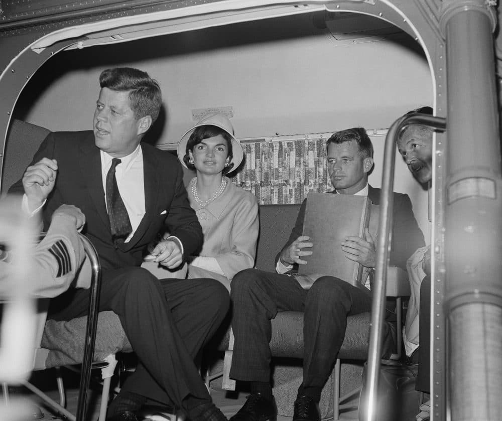 President John Kennedy gives the order to take off from Otis Air Force Base, Mass. for his summer home at nearby Hyannis Port via helicopter, June 30, 1961. Mrs. Jacqueline Kennedy in the center and brother Robert Kennedy, with briefcase, ride with the president. (AP)