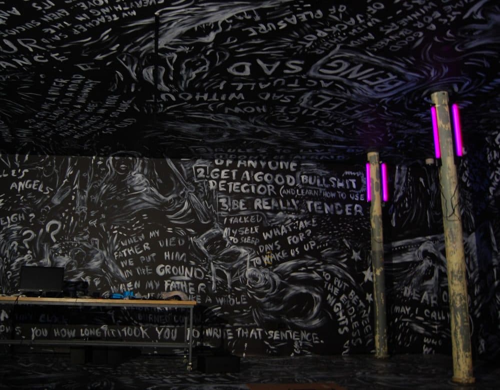 Laurie Anderson has painted all over the walls of one of the rooms (seen still in progress here) where she offers virtual reality experiences. (Greg Cook/WBUR)