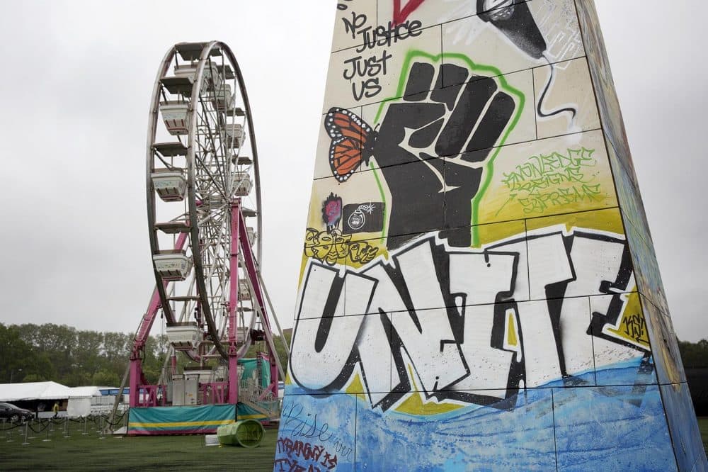 A few pieces of art and the Ferris wheel in the process of set up on Thursday afternoon. (Robin Lubbock/WBUR)