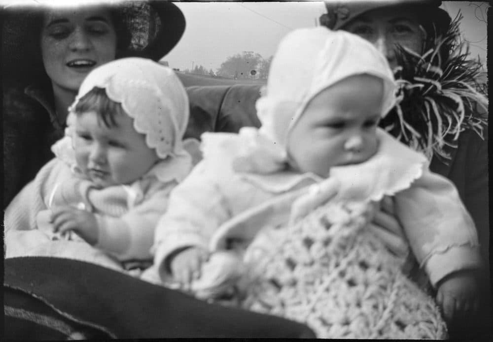 Joseph P. Kennedy, Jr., sits in the lap of his aunt, Agnes Fitzgerald, in Brookline, Massachusetts. Woman and baby at right are unidentified. (Courtesy JFK Library and Museum in Boston)