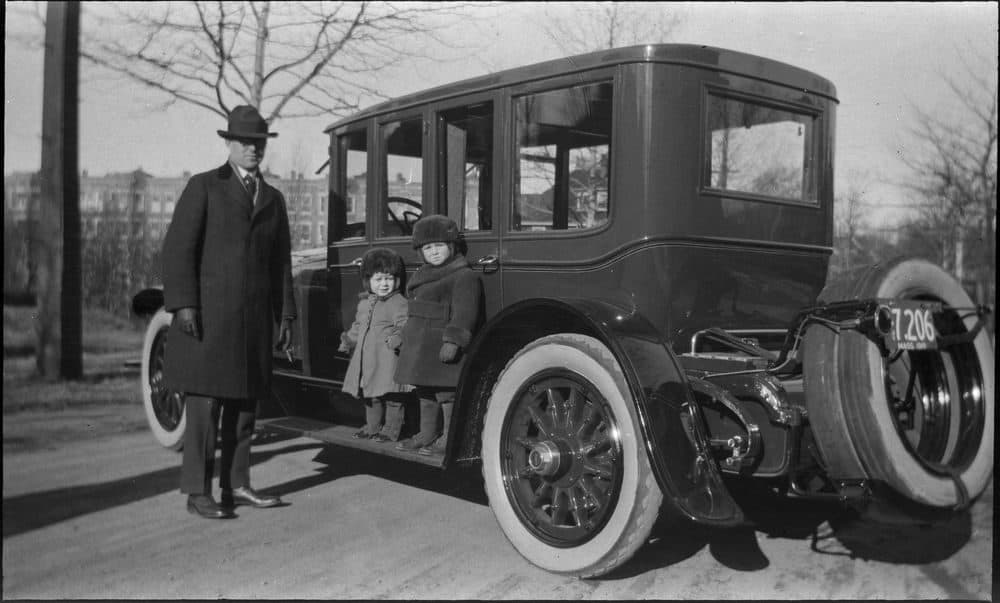 Joseph P. Kennedy, Sr., poses with his sons beside a car in Brookline, Massachusetts; Joseph P. Kennedy, Jr. (right), and John F. Kennedy stand on the car's running board. (Courtesy JFK Library and Museum in Boston)