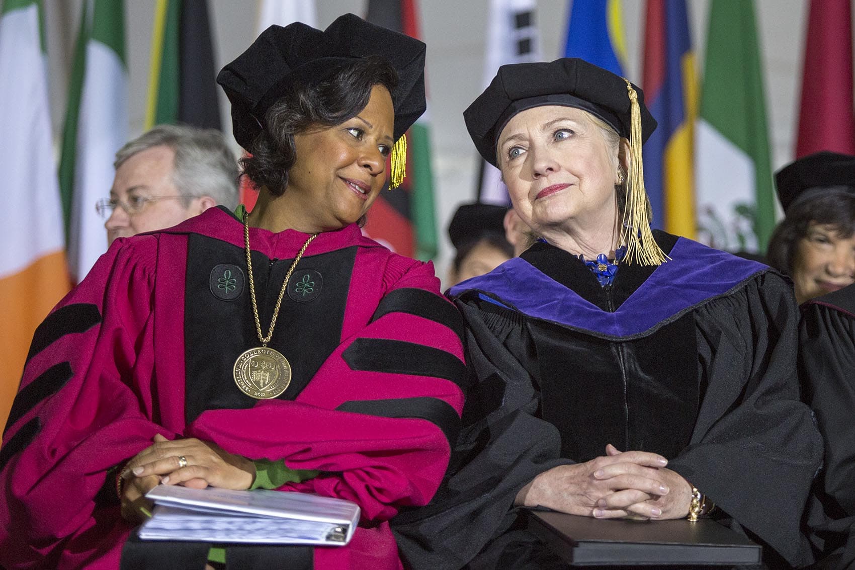 Wellesley College President Paula Johnson speaks with Hillary Clinton on stage during Friday's commencement. (Robin Lubbock/WBUR)