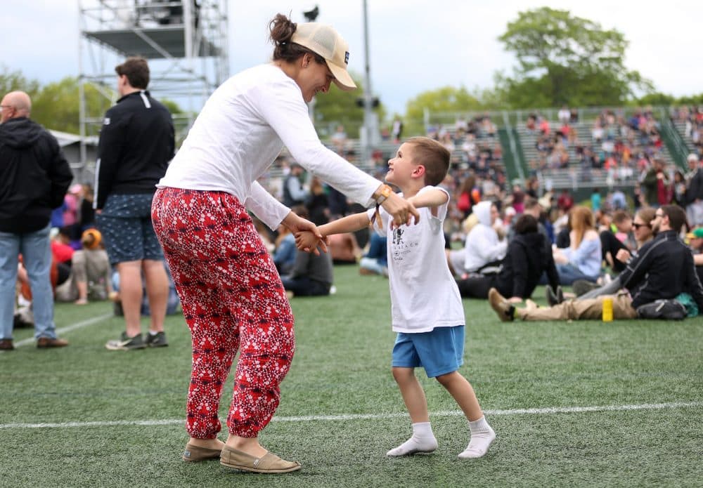 Katie Biello and her son Jude dance near the stage on Sunday. (Hadley Green for WBUR)