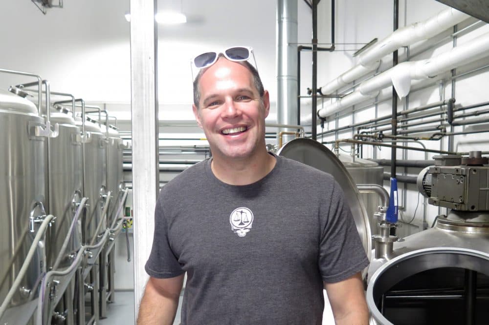 Matthew Steinberg inside his Exhibit A Brewing Company in Framingham. (Andrea Shea/WBUR)