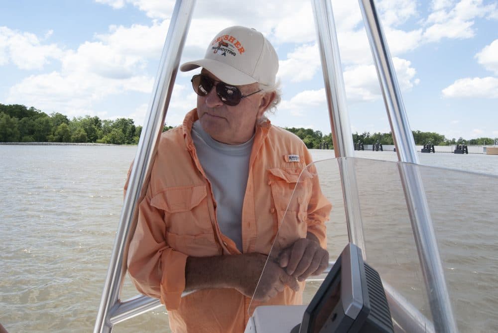 Kevin Rutley on a boat on the Barataria Waterway. His family has lived near the waterway since the Civil War. (Virginia Hanusik for Here &amp; Now)