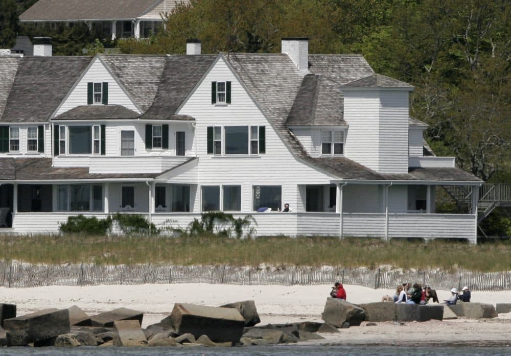 An unidentified man is seen reading on Sen. Edward M. Kennedy's porch Saturday on May 24, 2008 in Hyannisport, Mass. (Joel Page/AP)