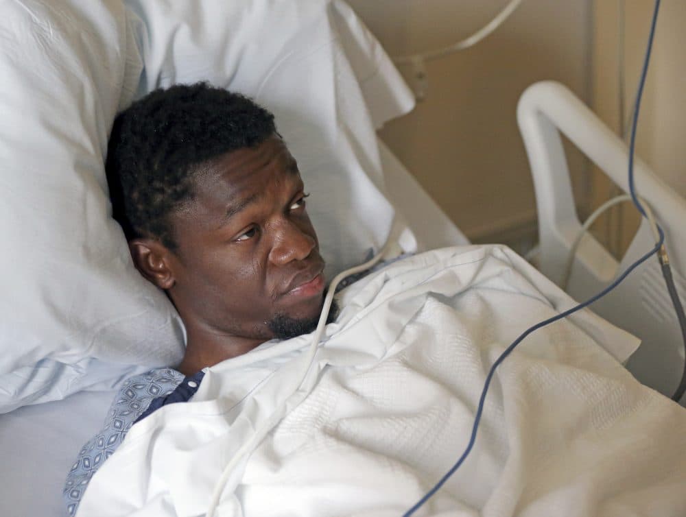 At Tufts Medical Center in Boston Monday, Bampumim Teixeira is arraigned on charges of murdering two engaged doctors in their South Boston penthouse condo. (David L Ryan/The Boston Globe/AP, Pool)