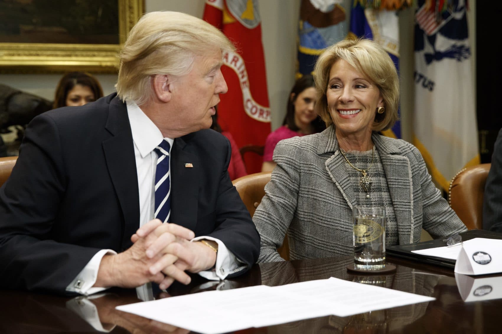 In this Feb. 14, 2017 file photo, President Donald Trump talks to Education Secretary Betsy DeVos in the Roosevelt Room of the White House in Washington. Even as fierce political battles rage in Washington over school choice, most Americans know little about charter schools or private school voucher programs. Still, more Americans feel positively than negatively about expanding those programs, according to a new poll released Friday, May 12, 2017. (Evan Vucci/AP)