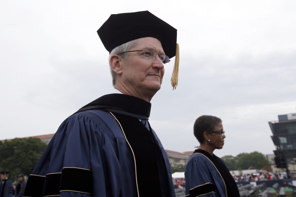 Apple CEO Tim Cook enters during George Washington University's commencement exercises on the National Mall, Sunday, May 17, 2015 in Washington. Cook gave the commencement address that year and was awarded an honorary doctorate in public service. (Alex Brandon/ AP)