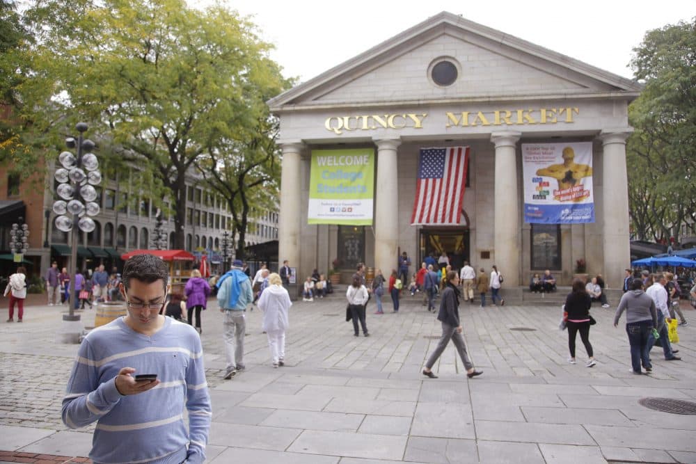 Pictured: Pedestrians and visitors to Quincy Market move through an open space between the Market and historic Faneuil Hall Tuesday, Oct. 7, 2014 in Boston. It has been four decades since Quincy Market became the inspiration for pedestrian city centers across the nation and now the market's new owners want to reimagine the iconic complex to fit the rapid redeveloping city around. (Stephan Savoia/AP)
