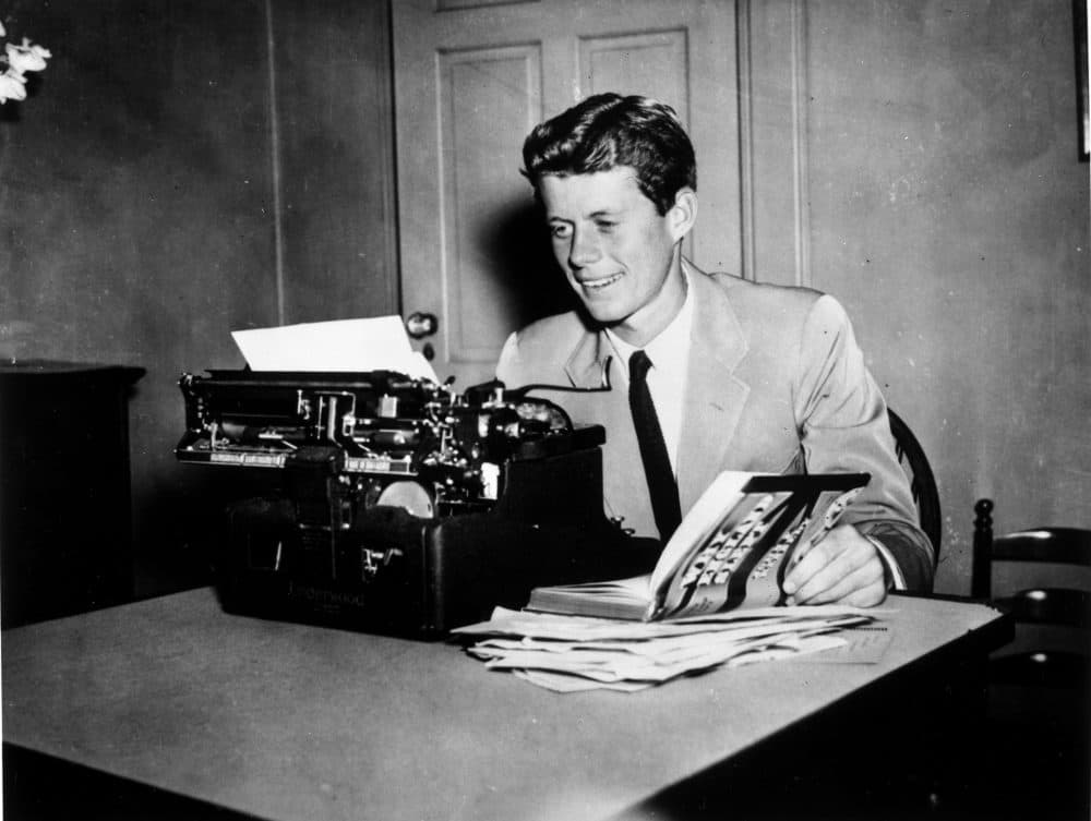 John F. Kennedy at a typewriter with his book &quot;Why England Slept.&quot; The book began as an honors thesis titled &quot;Appeasement at Munich.&quot; (John F. Kennedy Presidential Library)
