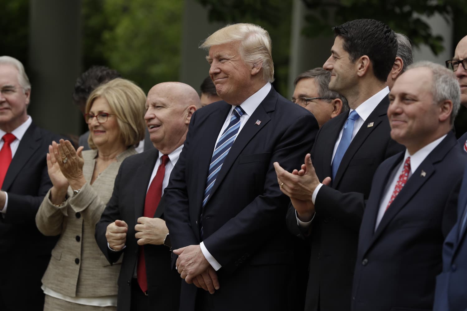 President Donald Trump, flanked by House Ways and Means Committee Chairman Rep. Kevin Brady, R-Texas, and House Speaker Paul Ryan of Wis., are seen in the Rose Garden of the White House in Washington. (Evan Vucci/AP)