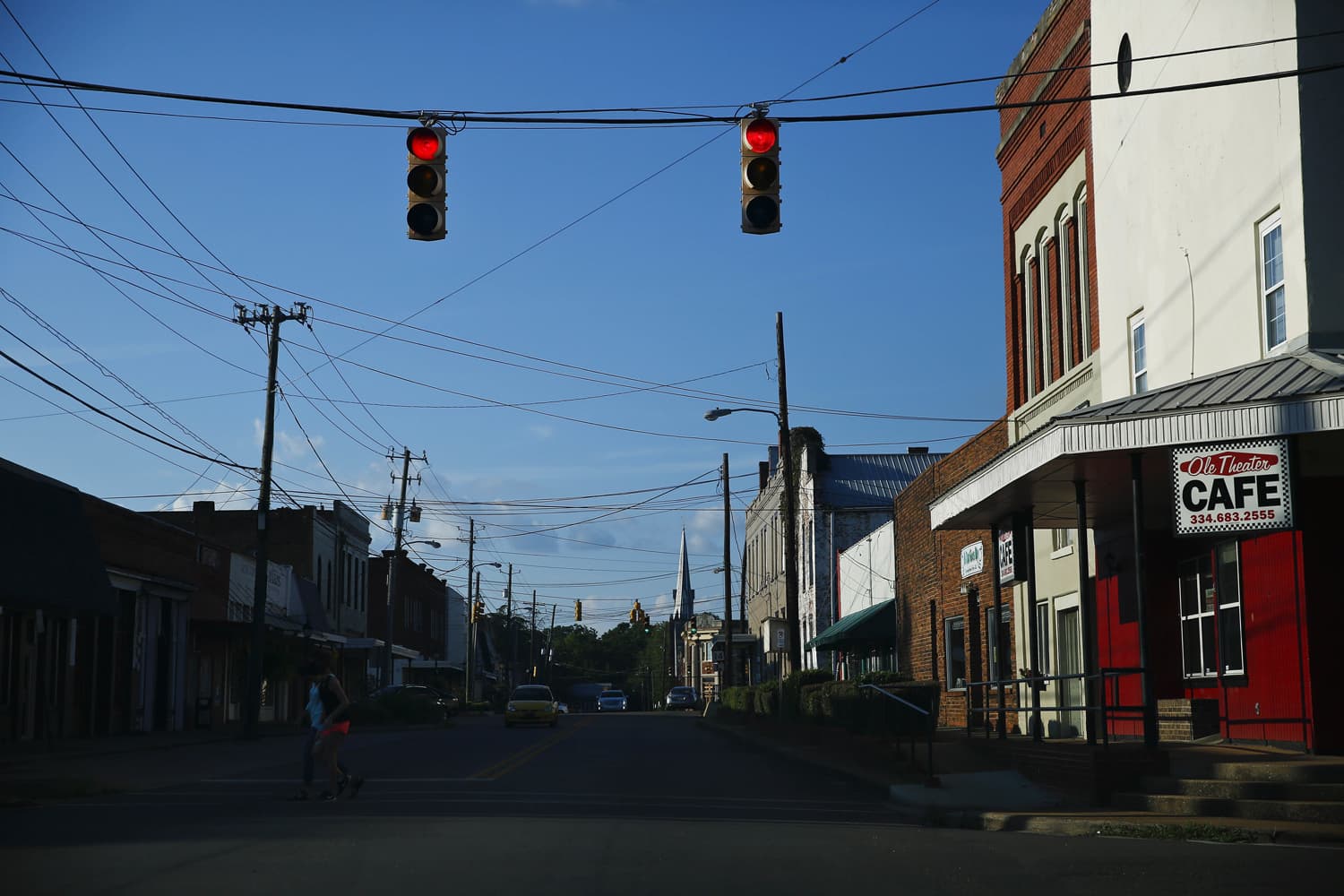 Two residents cross one of the main streets in downtown Marion, Ala., Wednesday, Aug. 24, 2016. Stretching from east Texas to southern Virginia, the impoverished area known as the Black Belt is heavily populated by blacks. (AP Photo/Brynn Anderson)