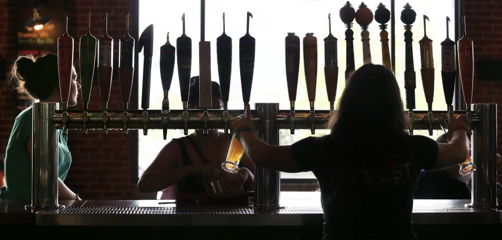 Pictured: A bartender at the Harpoon Brewery in the Seaport District of Boston in 2013. (Charles Krupa/AP)