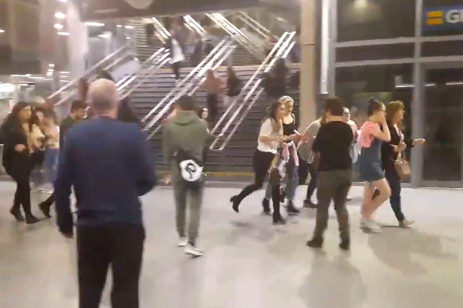 This image shows people running through Manchester Victoria station after an explosion at Manchester Arena. in Manchester England, Monday May 22, 2017. An apparent suicide bomber set off an improvised explosive device that killed over a dozen people at the end of an Ariana Grande concert on Monday, Manchester police said Tuesday May 23, 2017. The station is very near the arena. (Zach Bruce/PA via AP)