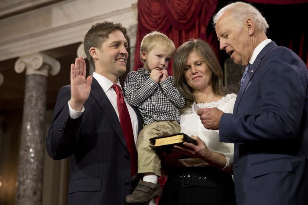 Vice President Joe Biden administers the Senate oath to Sen. Ben Sasse, R-Neb., holding his son Augustin, next to wife Melissa Sasse, on Jan. 6, 2015. (Jacquelyn Martin/AP)