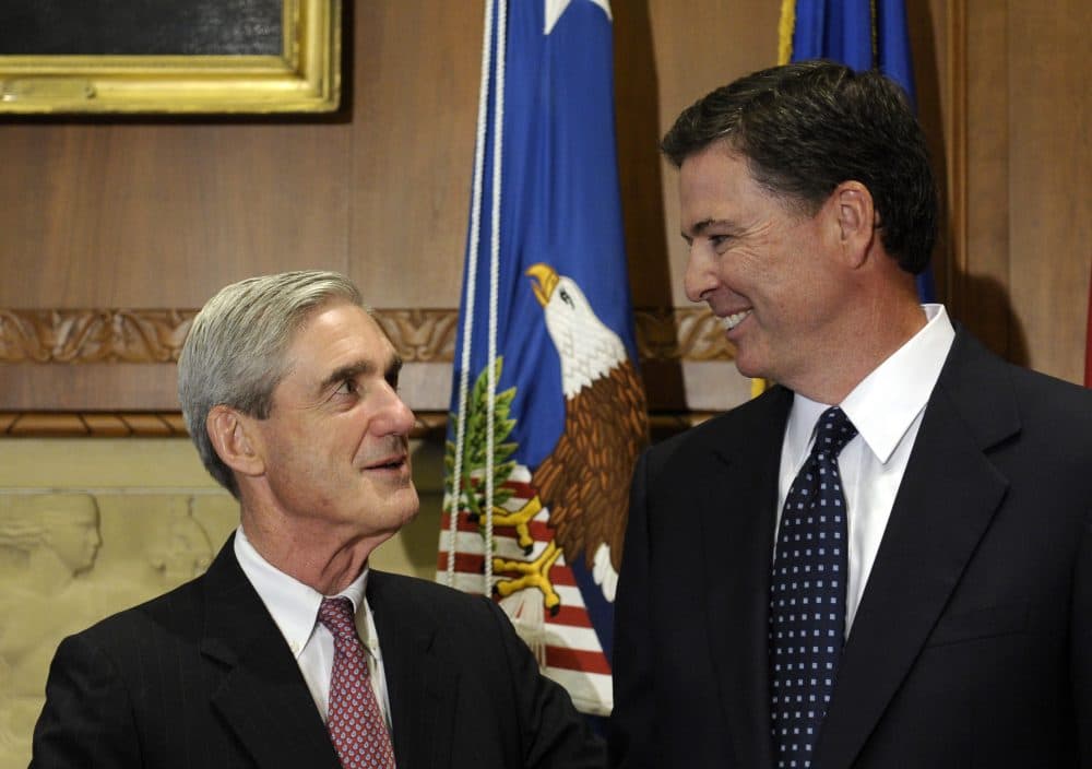Former FBI Director James Comey talks with his predecessor, former FBI Director Robert Mueller before Comey was officially sworn in at the Justice Department in Sept 2013. (Susan Walsh/AP)