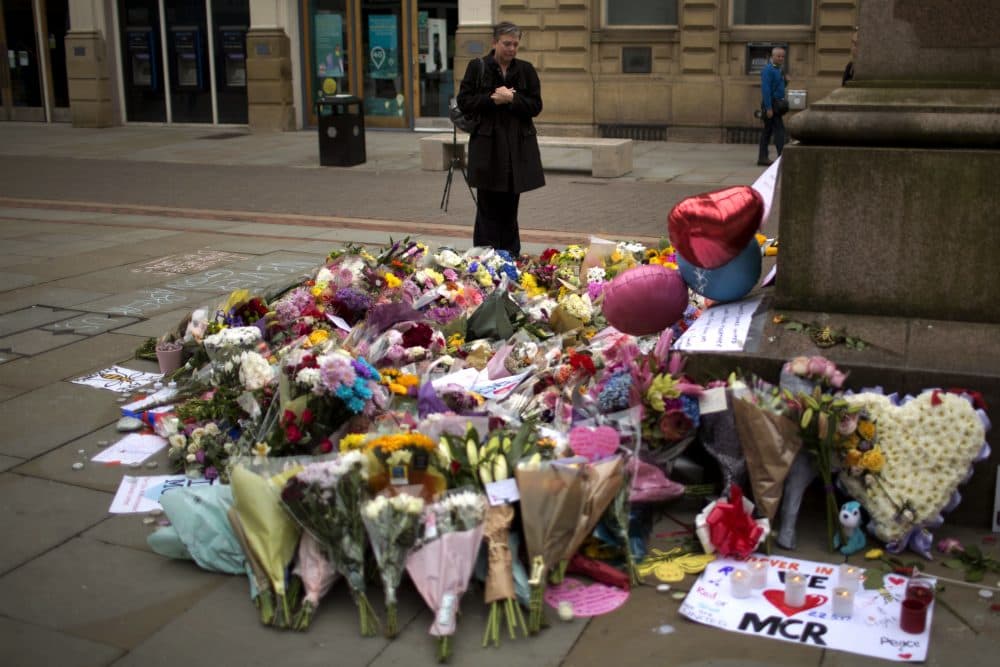 Tom Keane: "Depraved? Yes. Surprising? No." A woman stands next to flowers offered for the victims of the suicide attack that killed more than 20 people Monday night in central Manchester. (Emilio Morenatti/AP)