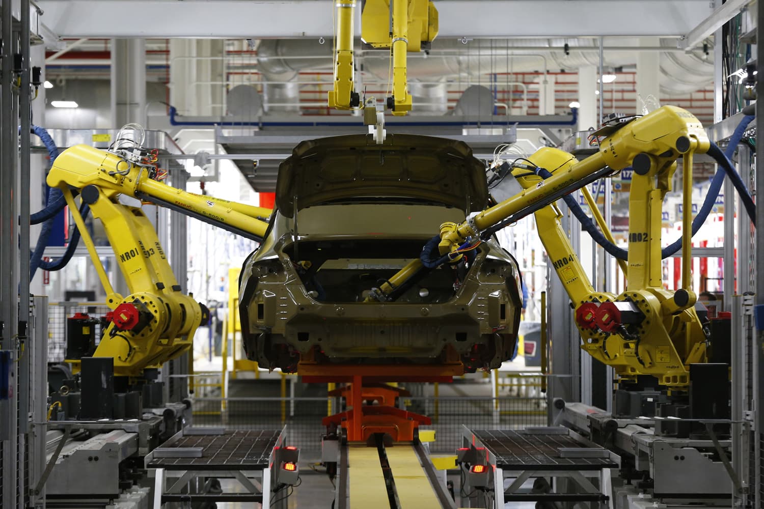 In this March 14, 2014 file photo, automated robots build a 2015 Chrysler 200 at the Sterling Heights Assembly Plant in Sterling Heights, Mich. (AP Photo/Paul Sancya, File)