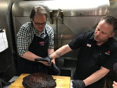 Chris Hart and Andy Husbands talk about the bark on the brisket. (Anthony Brooks/WBUR)