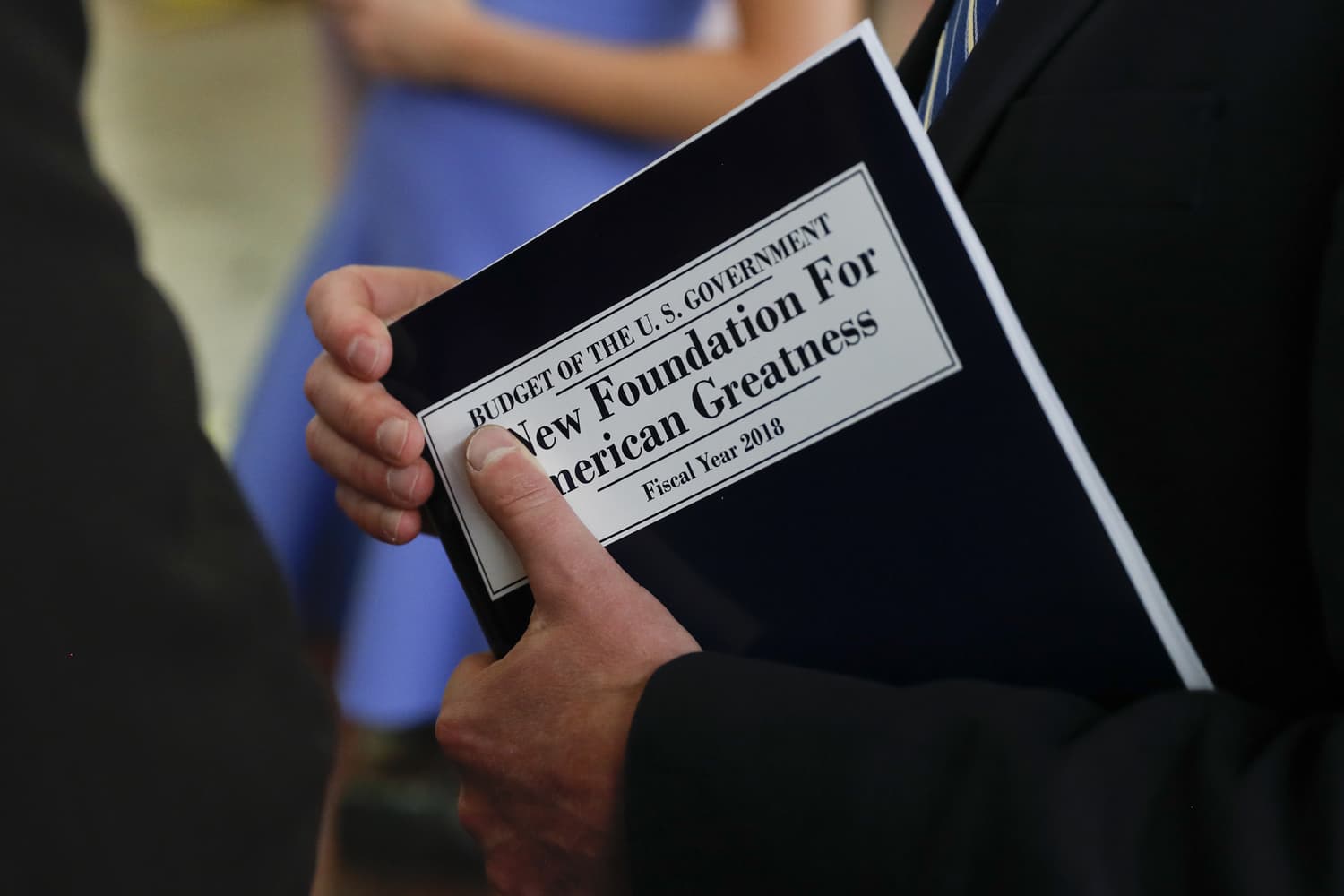White House budget director Mick Mulvaney, holds a copy of "Budget of the U.S. Government A New Foundation For American Greatness Fiscal Year 2018" as he inspects the production run of President Donald Trump's fiscal 2018 federal budget, Friday, May 19, 2017, at the U.S. Government Publishing Office's (GPO) plant in Washington. (AP Photo/Carolyn Kaster)