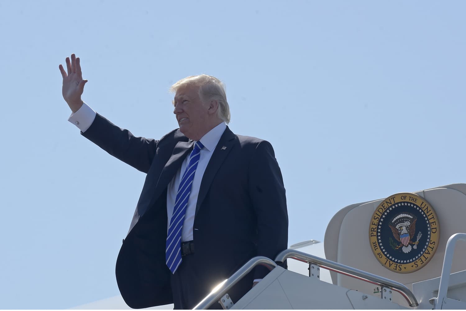 President Donald Trump waves as he walks off Air Force One at Groton-New London Airport in Groton, Conn., Wednesday, May 17, 2017. (AP Photo/Susan Walsh)