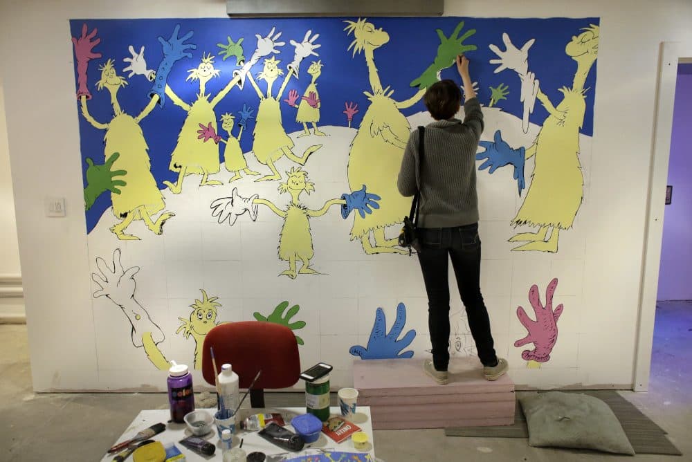 Cortney Thibodeau, a senior at UMass Amherst, paints a mural based on artwork from the Dr. Seuss book &quot;Oh, The Thinks You Can Think!&quot; (Steven Senne/AP)