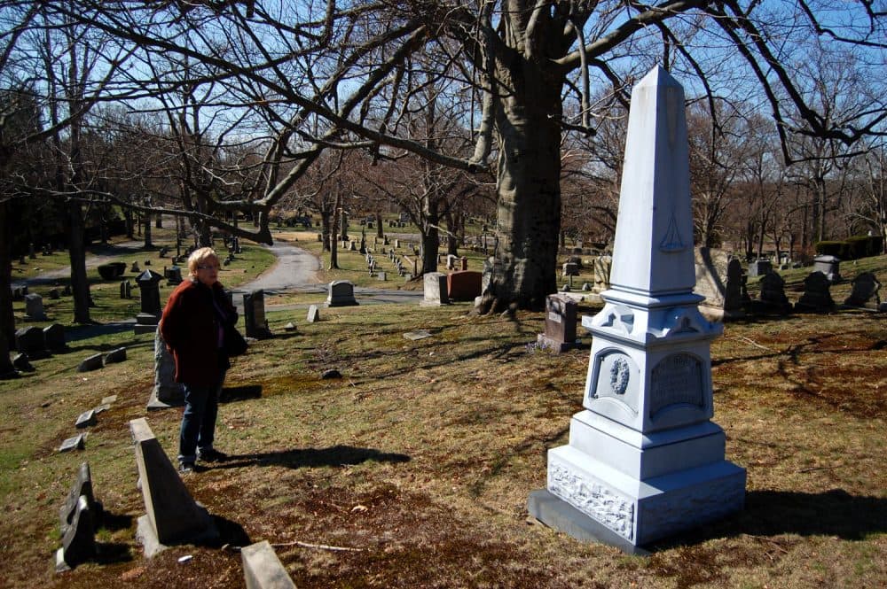 Dee Morris views the obelisk for members of the Cook family who served in and survived the “Mexican War.” (Greg Cook/WBUR)