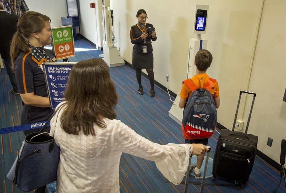 Passengers line up in front of a camera for biometric boarding. (Robin Lubbock/WBUR)