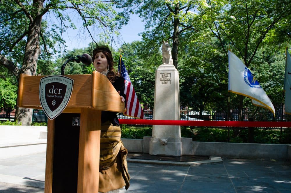 Joan Covino, dressed as Lotta Crabtree, sings &quot;Old Susanna&quot; at the reopening's ribbon cutting. (Elizabeth Gillis/WBUR)