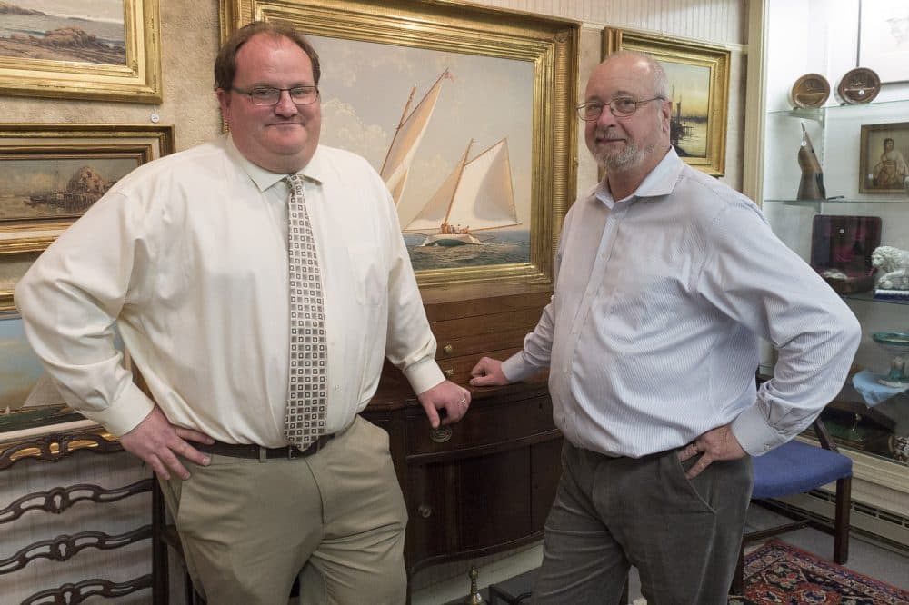 Josh Eldred (left) is president of Eldred's in Dennis. John Scofield (right) heads the Asian department and says business is up from an influx of online bidders. (Andrea Shea/WBUR)