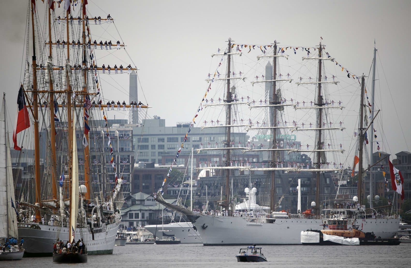 The Peruvian Navy tall ship Union, center, turns around in the inner harbor in front of the Chilean Navy tall ship Esmerelda, left, during Sail Boston's Parade of Sail. (Michael Dwyer/AP)