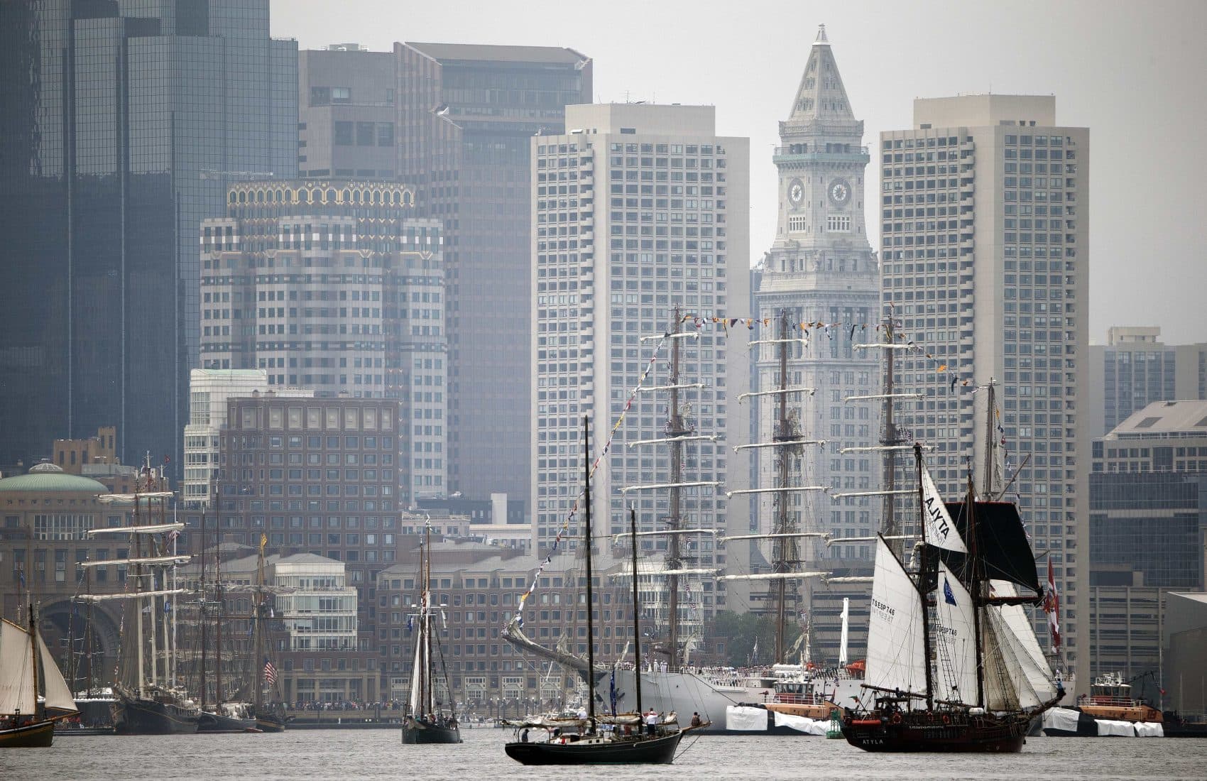 Tall ships pass in front of the skyline during Sail Boston's Parade of Sail on Saturday. (Michael Dwyer/AP)