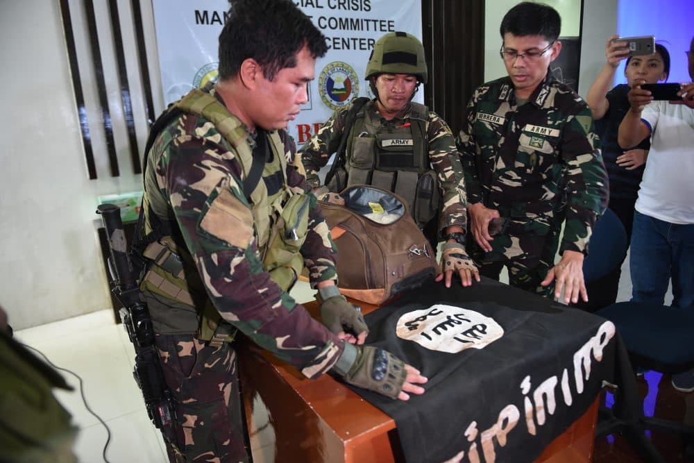 Philippine Army troopers prepare to display an ISIS flag and 11 kilograms of the illegal drug &quot;shabu,&quot; which were recovered from an Islamist militants position, prior to a press conference at the provincial capitol in Marawi on the southern island of Mindanao on June 19, 2017. (Ted Aljibe/AFP/Getty Images)