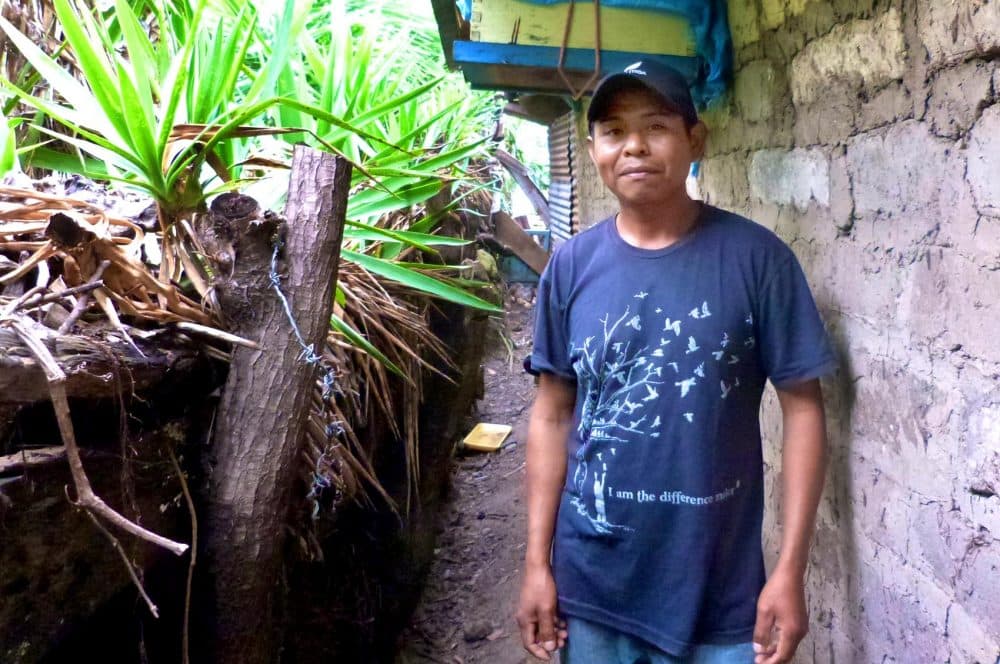 Coffee picker Jose Roher Lopez beside one of his beehives. He started the microbusiness because the decline of coffee picking opportunities was forcing him to go farther and farther from home during the picking season. (Karyn Miller-Medzon/Here &amp; Now)